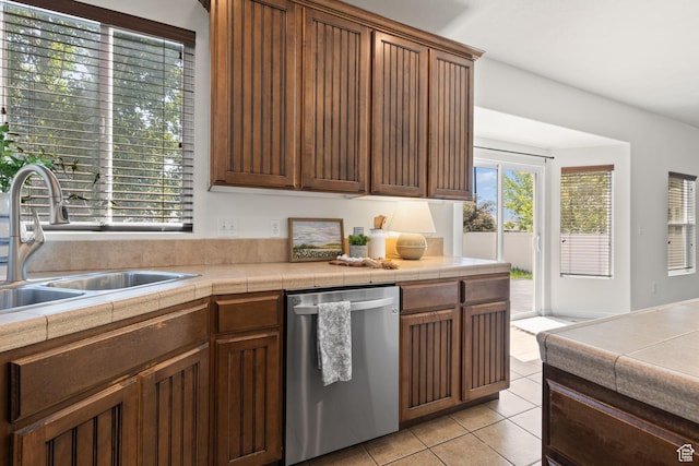 3991 W Hollandia Ln, West Jordan, UT 84084 - kitchen with stainless steel dishwasher, light tile patterned floors, and tile counters