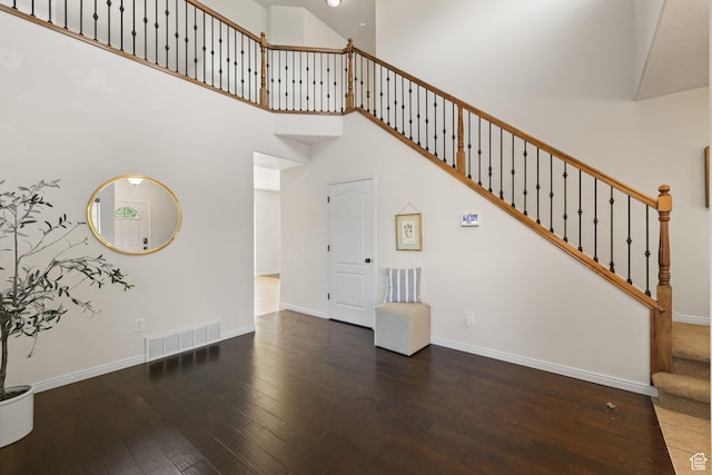 3991 W Hollandia Ln, West Jordan, UT 84084 - unfurnished living room with hardwood / wood-style flooring, stairway, and a towering ceiling