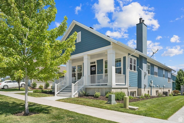 11103 S Kiwano Way W, South Jordan, UT 84009 - view of front of house with a chimney, covered porch, and a front lawn