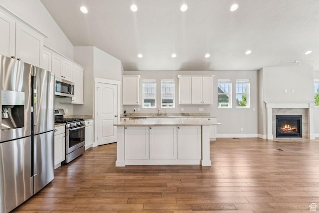11103 S Kiwano Way W, South Jordan, UT 84009 - kitchen featuring appliances with stainless steel finishes, open floor plan, a center island, white cabinets, and recessed lighting