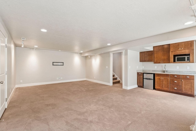 11103 S Kiwano Way W, South Jordan, UT 84009 - kitchen with fridge, stainless steel microwave, light colored carpet, light countertops, and recessed lighting