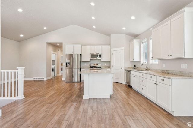 11103 S Kiwano Way W, South Jordan, UT 84009 - kitchen with appliances with stainless steel finishes, light countertops, white cabinets, vaulted ceiling, and recessed lighting