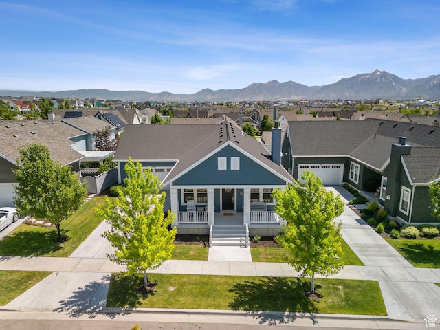 11103 S Kiwano Way W, South Jordan, UT 84009 - view of front of house featuring a residential view, a porch, driveway, and a mountain view