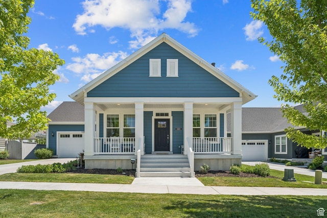 11103 S Kiwano Way W, South Jordan, UT 84009 - neoclassical home featuring an attached garage, a porch, driveway, and a front yard