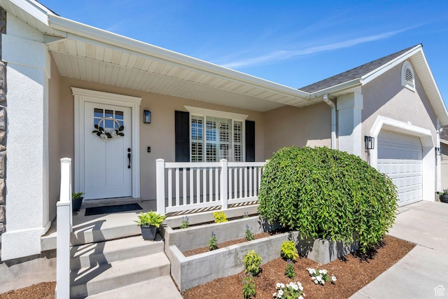 914 W Red Fox Ln, Saratoga Springs, UT 84045 - property entrance with stucco siding, an attached garage, covered porch, and concrete driveway
