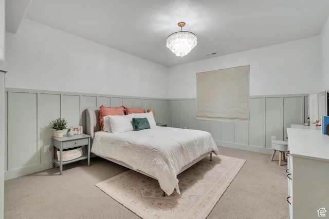 387 S 300 E, Midway, UT 84049 - bedroom with light carpet, a chandelier, a decorative wall, and a wainscoted wall