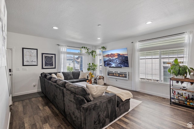 5680 W Pelican Ridge Ln, Salt Lake City, UT 84118 - living area featuring dark wood-style floors, recessed lighting, and a textured ceiling
