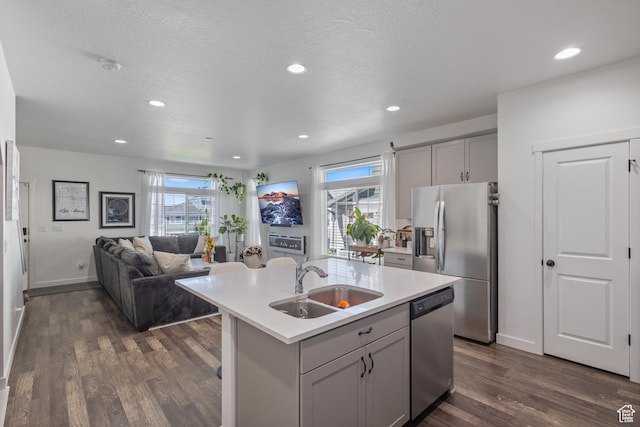 5680 W Pelican Ridge Ln, Salt Lake City, UT 84118 - kitchen featuring appliances with stainless steel finishes, gray cabinets, dark wood-style floors, healthy amount of natural light, and recessed lighting
