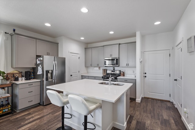 5680 W Pelican Ridge Ln, Salt Lake City, UT 84118 - kitchen featuring gray cabinets, stainless steel appliances, dark wood-style flooring, light countertops, and recessed lighting