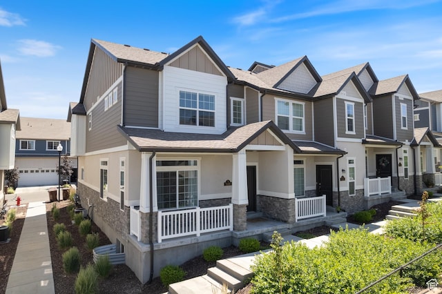 5680 W Pelican Ridge Ln, Salt Lake City, UT 84118 - view of front facade with stone siding, board and batten siding, a porch, a shingled roof, and a residential view