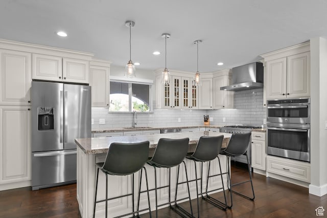 7968 S Titian St E, Cottonwood Heights, UT 84121 - kitchen with stainless steel appliances, wall chimney range hood, tasteful backsplash, light stone countertops, and a breakfast bar area