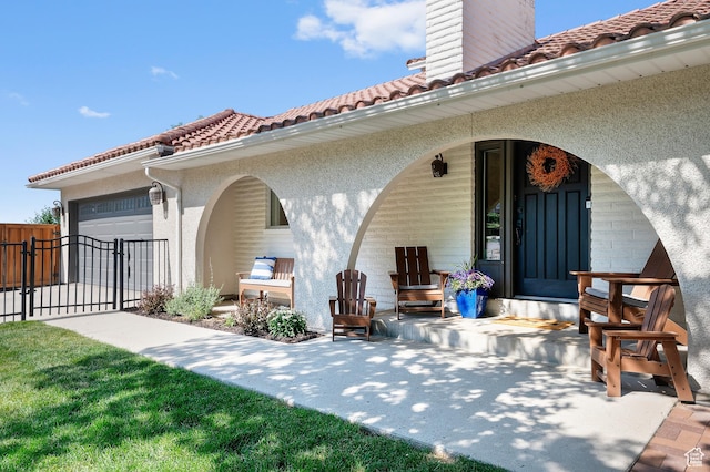 7968 S Titian St E, Cottonwood Heights, UT 84121 - back of property featuring a tile roof, stucco siding, a chimney, an attached garage, and a gate