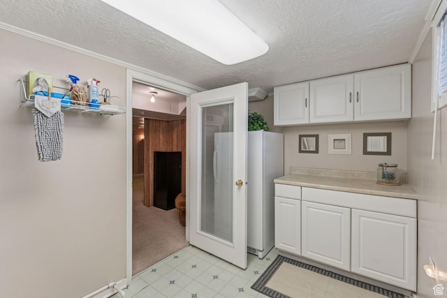 1492 S 2100 E, Salt Lake City, UT 84108 - kitchen featuring white cabinets, a textured ceiling, light countertops, a heating unit, and light floors