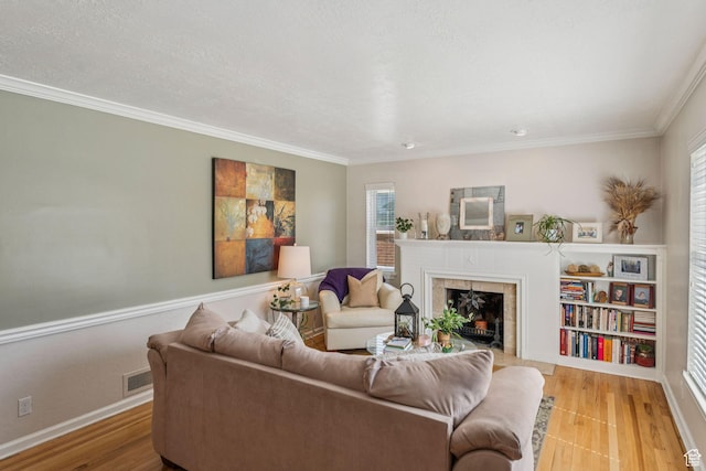 1492 S 2100 E, Salt Lake City, UT 84108 - living room with a tile fireplace, healthy amount of natural light, wood finished floors, and crown molding