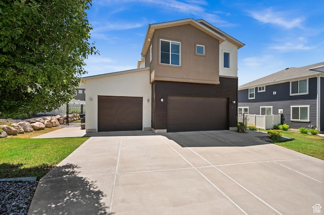 1578 E Maple Way, Layton, UT 84040 - view of front of house featuring stucco siding, driveway, and a garage