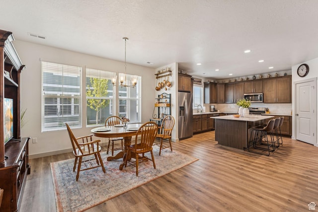 155 N 3830 W, West Point, UT 84015 - dining space with a chandelier, healthy amount of natural light, light wood-style flooring, and recessed lighting