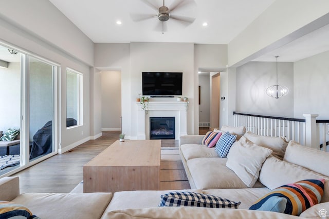 586 S Appenzell Ln W Unit 16, Midway, UT 84049 - living room with light wood finished floors, ceiling fan, recessed lighting, a glass covered fireplace, and a chandelier