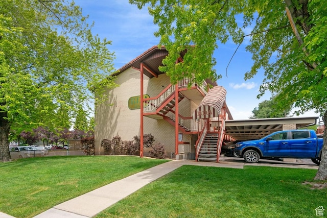 141 E 700 N Unit 29, Provo, UT 84606 - view of front of house featuring stairway, a front yard, and a carport