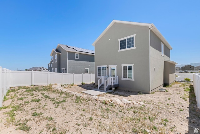 528 S Musk Ave W, Grantsville, UT 84029 - back of house with a fenced backyard and stucco siding