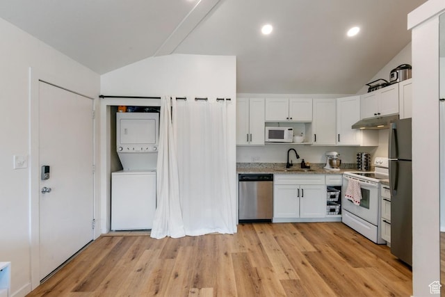 98 W 880 N Unit 6, Provo, UT 84604 - kitchen featuring appliances with stainless steel finishes, stacked washer and clothes dryer, lofted ceiling, white cabinets, and under cabinet range hood