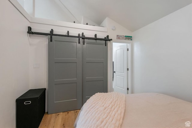 98 W 880 N Unit 6, Provo, UT 84604 - bedroom featuring vaulted ceiling, light wood-style floors, a barn door, and a closet
