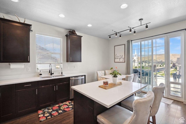 6228 N Boulter Peak Ln, Eagle Mountain, UT 84005 - kitchen featuring stainless steel dishwasher, a breakfast bar, healthy amount of natural light, light countertops, and recessed lighting