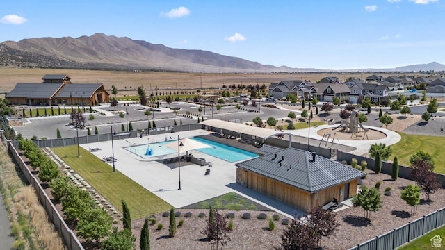 6228 N Boulter Peak Ln, Eagle Mountain, UT 84005 - aerial perspective of suburban area with a pool area and a mountainous background
