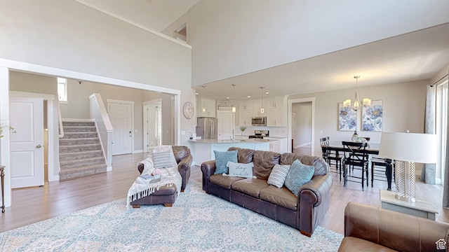 149 N 800 E, Salem, UT 84653 - living room with light wood-style floors, a chandelier, stairs, and plenty of natural light