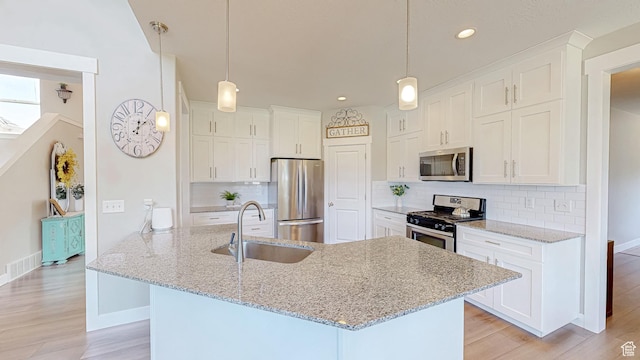149 N 800 E, Salem, UT 84653 - kitchen with stainless steel appliances, white cabinetry, light wood-style flooring, and recessed lighting