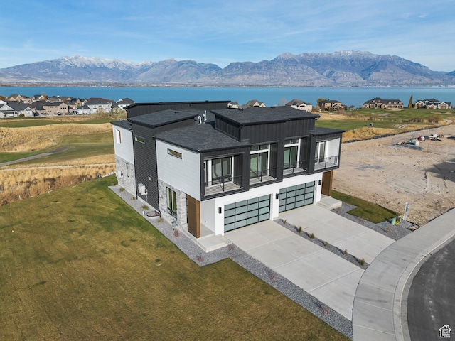 78 Watson Dr, Saratoga Springs, UT 84045 - view of front of home with a garage, a balcony, driveway, a shingled roof, and a front yard