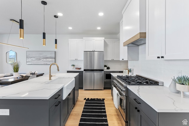 78 Watson Dr, Saratoga Springs, UT 84045 - kitchen featuring appliances with stainless steel finishes, light wood-style flooring, decorative backsplash, white cabinets, and recessed lighting