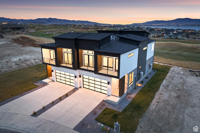 78 Watson Dr, Saratoga Springs, UT 84045 - contemporary home with roof with shingles, a mountain view, a balcony, an attached garage, and concrete driveway