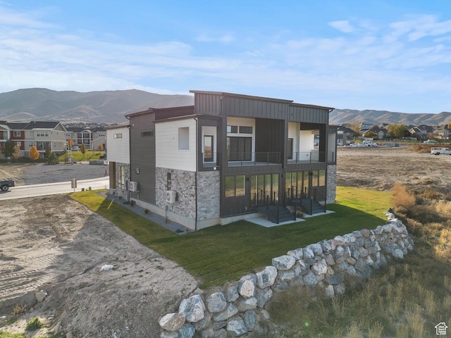 78 Watson Dr, Saratoga Springs, UT 84045 - rear view of property with a mountain view, a balcony, stone siding, and a lawn
