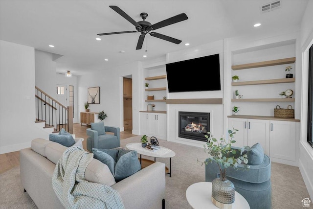 529 E 4290 S, Washington, UT 84780 - living room with built in shelves, ceiling fan, a glass covered fireplace, stairs, and recessed lighting