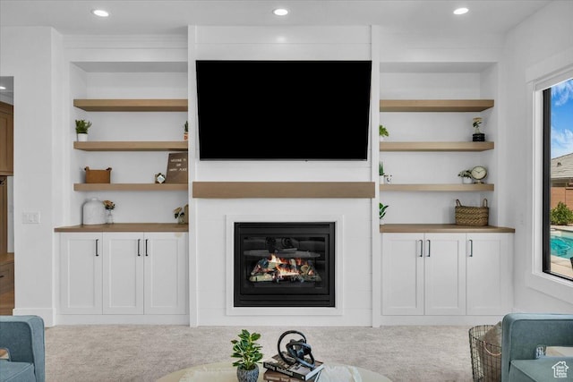 529 E 4290 S, Washington, UT 84780 - living room with carpet, built in shelves, a glass covered fireplace, and recessed lighting