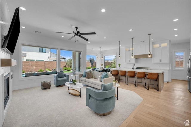 529 E 4290 S, Washington, UT 84780 - living room with recessed lighting, light wood-type flooring, a glass covered fireplace, and a ceiling fan