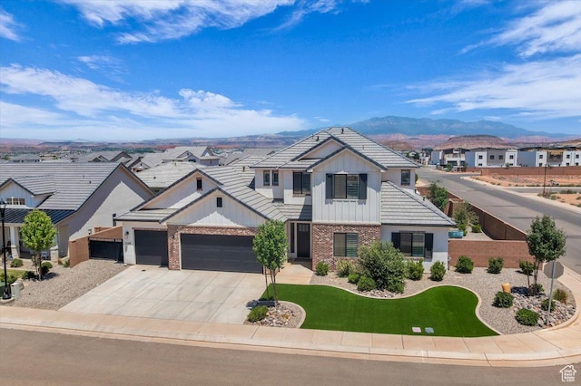 529 E 4290 S, Washington, UT 84780 - view of front of home featuring brick siding, an attached garage, board and batten siding, concrete driveway, and a mountain view