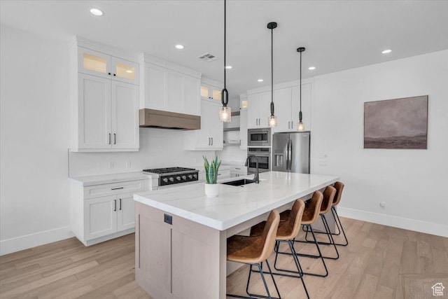 529 E 4290 S, Washington, UT 84780 - kitchen featuring appliances with stainless steel finishes, light wood-style flooring, extractor fan, white cabinetry, and glass insert cabinets