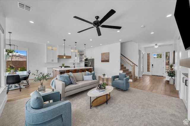 529 E 4290 S, Washington, UT 84780 - living area with light wood-type flooring, plenty of natural light, stairway, and recessed lighting