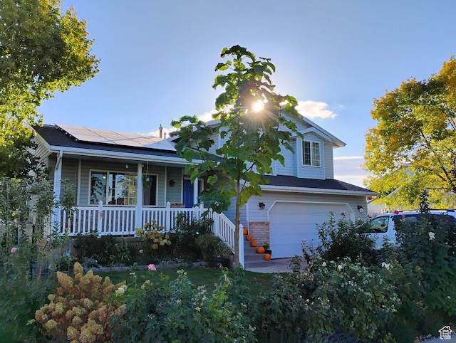 665 S 1040 E, Spanish Fork, UT 84660 - view of front of property featuring a porch, a garage, and roof mounted solar panels