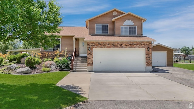 4403 W 3850 S, West Haven, UT 84401 - split level home with a front lawn, a garage, brick siding, driveway, and a shingled roof
