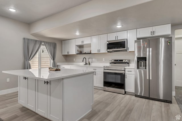 992 W Emily Francis Cir S, Jordan, UT 84095 - kitchen with appliances with stainless steel finishes, light wood-style floors, light countertops, white cabinets, and recessed lighting