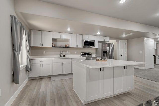992 W Emily Francis Cir S, Jordan, UT 84095 - kitchen featuring appliances with stainless steel finishes, light wood-style floors, white cabinets, light countertops, and recessed lighting