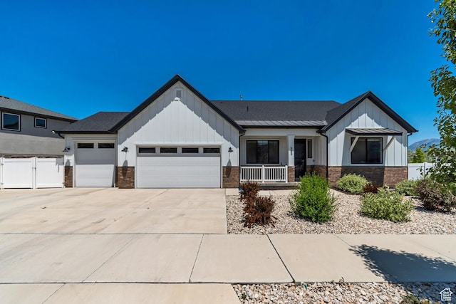 992 W Emily Francis Cir S, Jordan, UT 84095 - modern farmhouse style home with board and batten siding, a porch, a garage, driveway, and brick siding