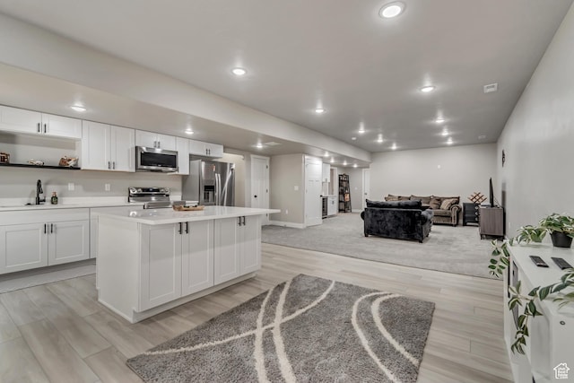 992 W Emily Francis Cir S, Jordan, UT 84095 - kitchen featuring stainless steel appliances, open floor plan, light countertops, open shelves, and a kitchen island