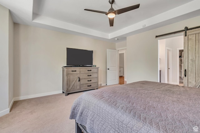 992 W Emily Francis Cir S, Jordan, UT 84095 - bedroom featuring a barn door, light carpet, a raised ceiling, and ceiling fan