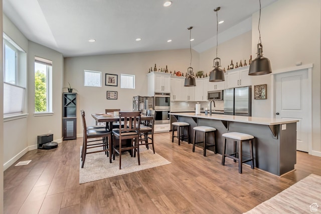 992 W Emily Francis Cir S, Jordan, UT 84095 - dining area with light wood-type flooring, high vaulted ceiling, and recessed lighting