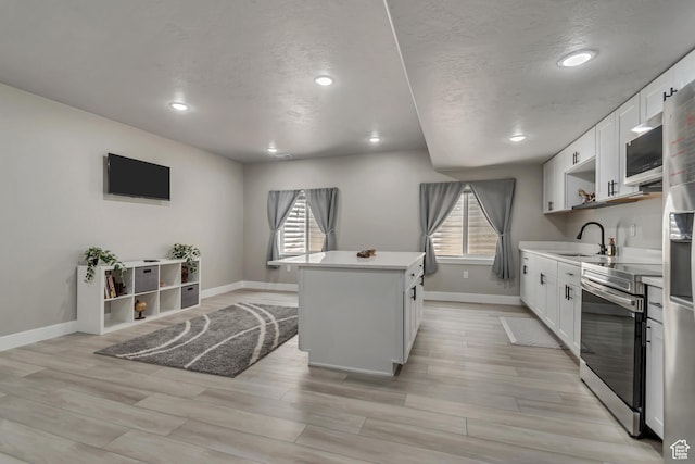 992 W Emily Francis Cir S, Jordan, UT 84095 - kitchen featuring stainless steel appliances, a kitchen island, white cabinetry, recessed lighting, and light countertops
