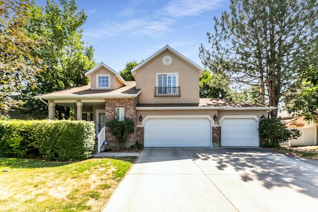 11805 S Sunset Ponds Dr Unit 5, Draper, UT 84020 - view of front of home with driveway, stucco siding, an attached garage, a shingled roof, and a front lawn