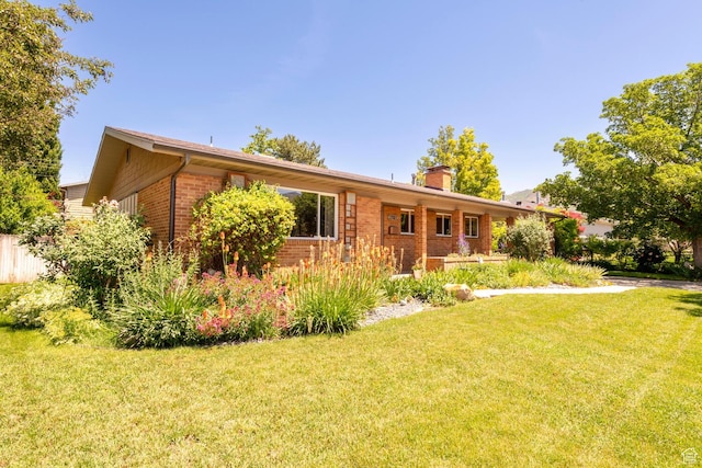 1983 E 1700 S, Salt Lake City, UT 84108 - ranch-style home with brick siding, a chimney, and a front lawn